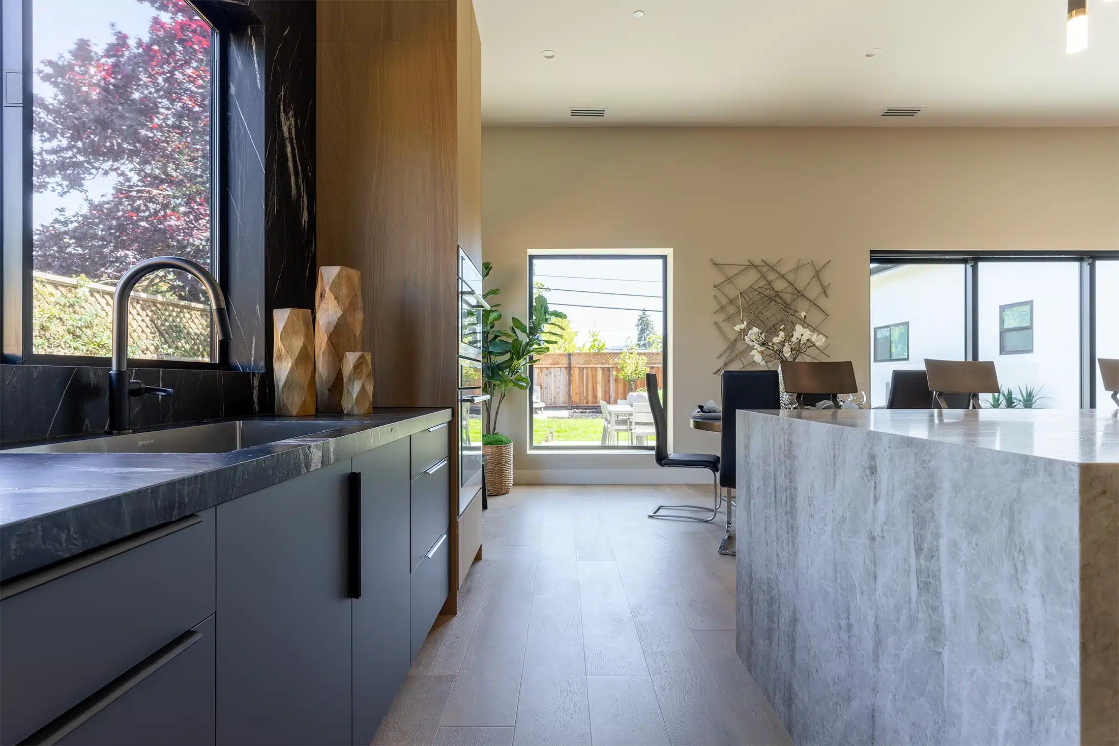 Kitchen island and sink counter opening onto the dining area and yard